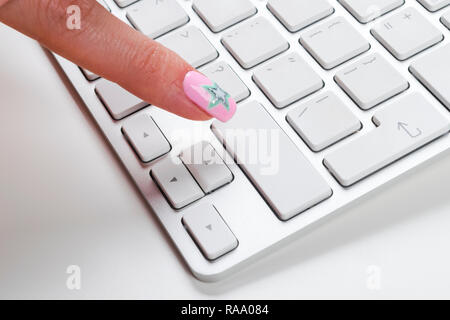 Close up view of a Finger Pushing on a empty Button of computer Keyboard. Finger Pressing a Slim Aluminum Keyboard Button. Modern Laptop Keyboard. Emp Stock Photo