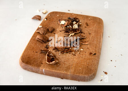 Cracked walnuts on wooden board Stock Photo