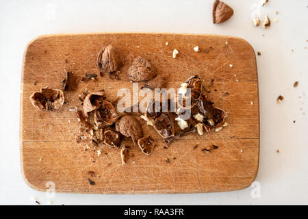 Crushed walnuts on wooden board top view Stock Photo