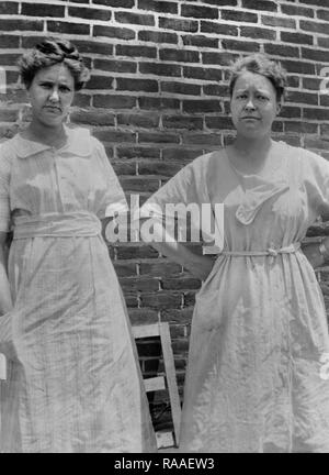 Two middle aged women stand for a portrait, ca. 1930. Stock Photo