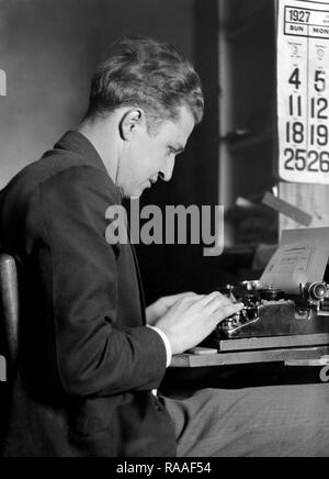 A man types a check on a typewriter, ca. 1927. Stock Photo