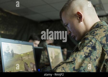 U.S. Marine Corps Pfc. Dustin L. Bollinger, a rifleman with Echo Company, 2nd Battalion, 6th Marine Regiment, 2nd Marine Division (2d MARDIV), utilizes combat tactics using Virtual Battlespace 3 (VBS 3) while competing in the Spartan Tactical Games on Camp Lejeune, N.C., Jan. 10, 2017. VBS 3 and the Spartan Tactical Games allow the Marines to test their tactical and cognitive thinking while competing against each other on a squad level. Stock Photo