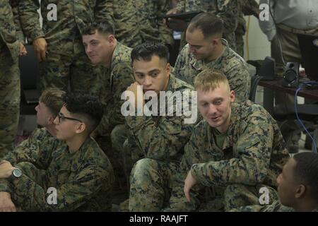 U.S. Marines with Echo Company, 2nd Battalion, 6th Marine Regiment, 2nd Marine Division (2d MARDIV), gather to receive a debrief after utilizing Virtual Battlespace 3 (VBS 3) during the Spartan Tactical Games on Camp Lejeune, N.C., Jan. 10, 2017. VBS 3 and the Spartan Tactical Games allow the Marines to test their tactical and cognitive thinking while competing against each other on a squad level. Stock Photo