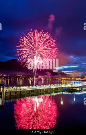 July 4th fireworks from downtown in the harbor of Juneau, Southeast Alaska, USA. Stock Photo