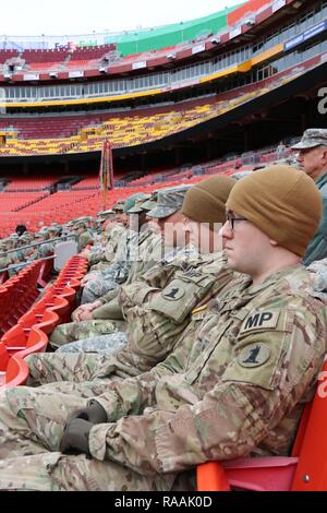 Soldiers with the Delaware Army National Guard's 153rd Military Police Company listen to a briefing before being sworn in as District of Columbia special police at FedEx Field in Landover, Md., Jan. 19, 2017. The Delaware MPs are here in preparation of the 58th Presidential Inauguration. During the historic event, National Guard troops from almost every state and territory will provide several critical functions including crowd management, traffic control, emergency services, logistics, and ceremonial marching elements. Stock Photo