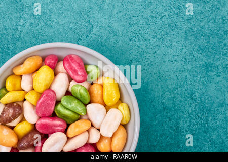 Colorful candies in a bowl, space for text. Stock Photo
