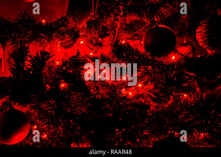 christmas ball in a christmas tree with red lights Stock Photo