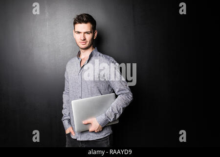 Smiling man using his laptop on white background Stock Photo