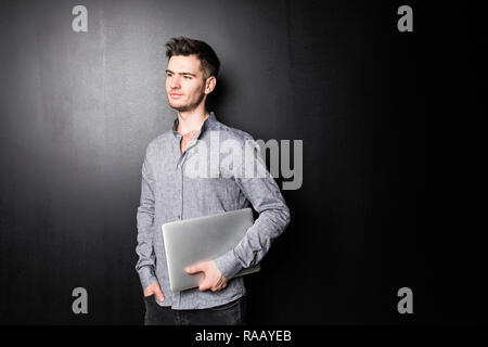 Smiling man using his laptop on white background Stock Photo