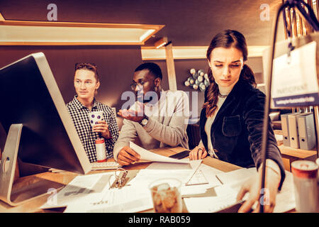 Concentrated brunette woman staring at her gadget Stock Photo