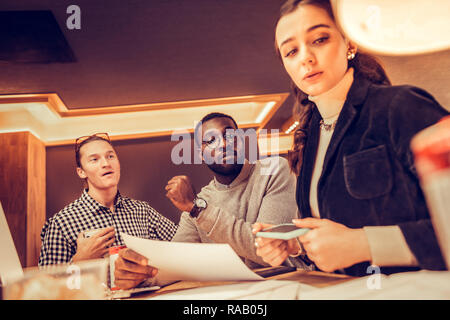 Concentrated young people working at their project Stock Photo