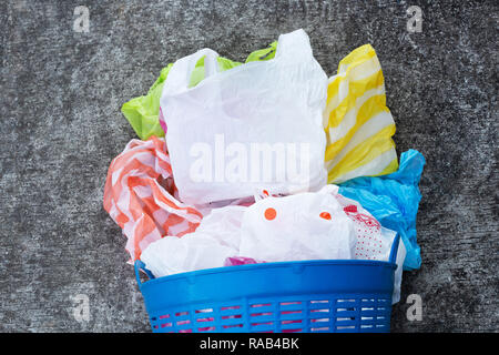 Colorful plastic bags on cement floor background Stock Photo