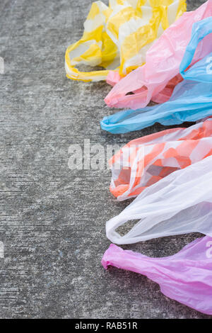 Plastic garbage bags on cement floor. Copy space Stock Photo