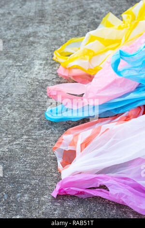 Plastic garbage bags on cement floor background. Stock Photo