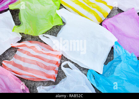 Plastic garbage bags on cement floor background. Stock Photo