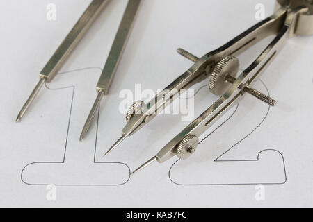 A companion for drawing circles on a white piece of paper. Drafting accessories for drawing technical drawings. Light background. Stock Photo
