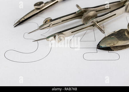 Nib for drafts on a white sheet. Drawing tools needed to draw technical drawings. Light background. Stock Photo
