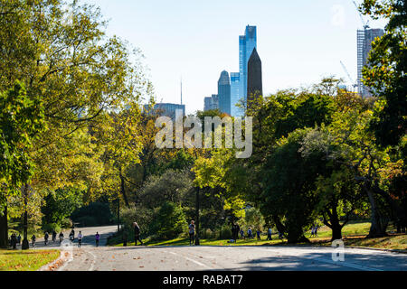 NEW YORK - UNITED STATES - 30 NOVEMBER 2018. Some people are walking and riding bicycles in the beautiful and colorful Central Park, Manhattan, New Yo Stock Photo