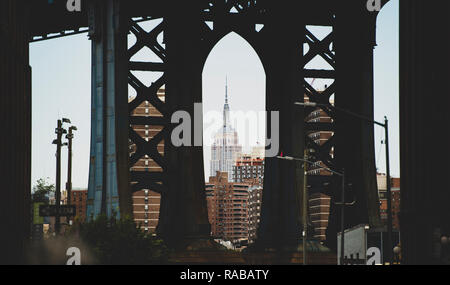 Spectacular view of the Empire State Building seen through the Manhattan bridge in Dumbo neighborhood. Stock Photo