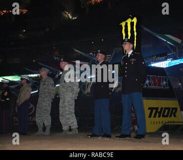 U.S. Army Spc. Taylor Miller (far right) and Eduardo Negron (2nd from right), Horse Detachment, 11th Armored Cavalry Regiment, along with other service members stand on the Monster Energy AMA Supercross race track during Military Appreciation Night at Petco Park in San Diego, Jan. 14, 2017. Blackhorse Troopers assigned to the Horse Detachment presented the colors to the 30,000 fans in attendance during the singing of the Star-Spangled Banner. Stock Photo