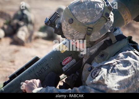 Pfc. Robert Evens, 1st Battalion, 24th Infantry Regiment, Ft. Wainright, Alaska, prepares to fire an FGM-148 Javelin during the training exercise, NTC 17-03, National Training Center, Ft. Irwin, CA., Jan. 14, 2017. The National Training Center conducts tough, realistic, Unified Land Operations with our United Action Partners to prepare Brigade Combat Teams and other units for combat while taking care of Soldiers, Civilians, and Family members. Stock Photo