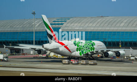 Dubai, UAE - Dec 9, 2018. An Airbus A380 airplane of Emirates docking at Dubai Airport (DXB). DXB is the third-busiest airport in the world. Stock Photo