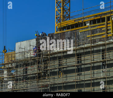 Dubai, UAE - Dec 9, 2018. Laborers working on modern construction site works in Dubai, UAE. Stock Photo