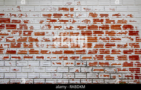 White peeling painted as old red brick wall. Stock Photo