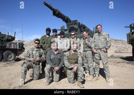 U.S. Army Soldiers assigned to the 1st Cavalry Regiment, 1/25 SBCT 'Arctic Wolves' pose for a group photo as this is the last mission for 19 kilos, National Training Center, Ft. Irwin, CA., Jan. 18, 2017. The National Training Center conducts tough, realistic, Unified Land Operations with our United Action Partners to prepare Brigade Combat Teams and other units for combat while taking care of Soldiers, Civilians, and Family members. Stock Photo