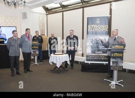 German Army Lt. Gen. Jörg Vollmer, Chief of Staff of the German Army (right) presents his remarks during the Patch Ceremony conducted by Lt. Gen. Ben Hodges, Commanding General of U.S. Army Europe (center) for the incoming U.S. Army Europe (USAREUR) Chief of Staff (CoS), German Army Brig. Gen. Kai Rohrschneider (left) and the outgoing USAREUR CoS, German Army Brig. Gen. Markus Laubenthal (second from left) on Lucius D. Clay Kaserne in Wiesbaden, Germany, Jan. 26, 2017. Stock Photo