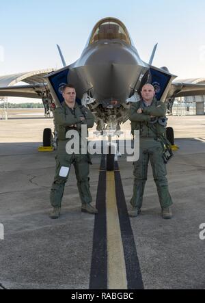 Florida Air National Guard pilots Lt. Col. Scott “Gaucho” Charlton (Left) and Maj. John “Rocky” MacRae (Right) stand in front of the F-35A Lightning II at Eglin Air Force Base January 24, 2017. Gaucho and Rocky are both F-35 instructor pilots with the 58th Fighter Squadron based at Eglin and are responsible for teaching pilots how to fly the Department of Defense’s newest aircraft. Stock Photo