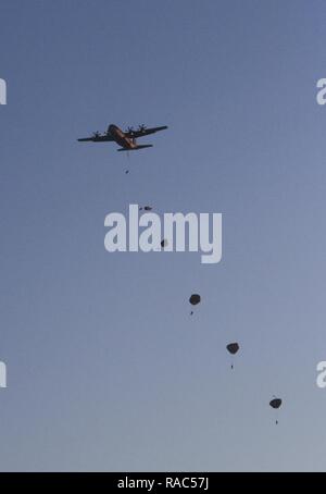 CAMP ADAZI, Lativa – Paratroopers assigned to Chosen Company, 2nd Battalion, 503rd Infantry Regiment, 173rd Airborne Brigade, jump from a C-130 Hercules aircraft during an airborne insertion at Adazi Training Area, Latvia, Jan. 11, 2017. Freezing conditions honed the Paratroopers’ ability to conduct operations in harsh environments and in support of Latvian forces. The ‘Sky Soldiers’ of 2nd Bn., 503rd Inf. Regt. are on a training rotation in support of Operation Atlantic Resolve, a U.S. led effort in Eastern Europe that demonstrates U.S. commitment to the collective security of NATO and dedica Stock Photo