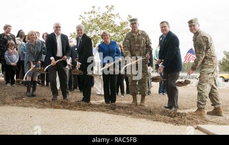 Dignitaries and Gold Star Families throw the first shovel of dirt during the memorial groundbreaking ceremony at the Camp Shelby Joint Forces Training Center's Mississippi Armed Forces Museum Jan. 11, 2017. Pictured left to right: Jenny Smith and her husband, Eddie; Mississippi Gov. Phil Bryant and his wife, Deborah; Maj. Gen. Janson Boyles, the adjutant general of Mississippi; Hoss Ladner, representative from Congressman Steven Palazzo's office; and Col. Greg Michel, Camp Shelby Joint Forces Training Center commander. Stock Photo