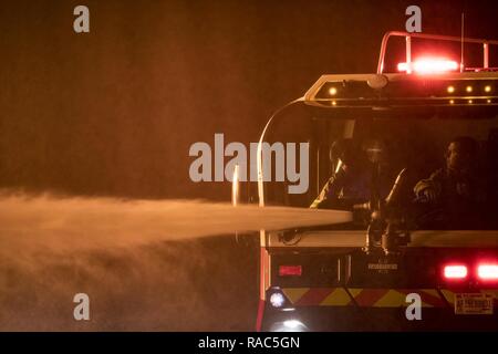 Firefighters from the 23d Civil Engineer Squadron use a P-23 Airport Rescue Fire Fighting vehicle during nighttime, live-fire training, Jan. 10, 2017, at Moody Air Force Base, Ga. The P-23 is primarily used to respond to aircraft fuel fires using its 3,300 gallons of water, 500 gallons of fire-retardant foam and 500lbs of dry powder. There are 250 P-23s in the Air Force inventory across active duty, Air National Guard and Air Force Reserve bases. Stock Photo