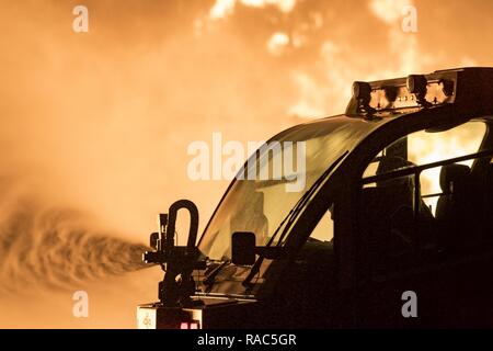 Firefighters from the 23d Civil Engineer Squadron use a P-23 Airport Rescue Fire Fighting vehicle during nighttime, live-fire training, Jan. 10, 2017, at Moody Air Force Base, Ga. The P-23 is primarily used to respond to aircraft fuel fires using its 3,300 gallons of water, 500 gallons of fire-retardant foam and 500lbs of dry powder. There are 250 P-23s in the Air Force inventory across active duty, Air National Guard and Air Force Reserve bases. Stock Photo