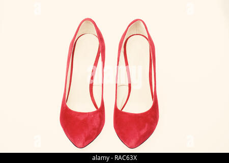 Footwear for women with thin high heels. Pair of fashionable high heeled pump shoes.Elegant stiletto shoes concept. Shoes made out of red suede on white background, isolated. Stock Photo