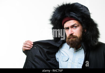 Guy wear hat and black winter jacket. Stylish and comfortable. Hipster  style menswear. Hipster outfit. Man bearded hipster stand in warm black  jacket parka isolated on white. Hipster modern fashion Stock Photo