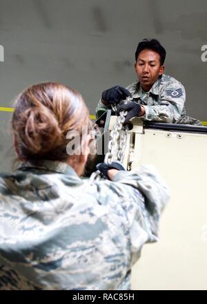 Tech. Sgt. Geofrey Erese, Eagle Vision Data Integration Segment non-commission officer-in-charge, unchains a hard-sided shelter shortly after arriving at Clark Air Base, Philippines, Jan. 14, 2017. Erese is a Hawaii Air National Guardsman deployed to the Philippines to support a Pacific Air Forces Subject Matter Expert Exchange between the U.S. and Philippine Air Forces. The SMEE focuses on the employment of a ground-based commercial satellite imaging system, called Eagle Vision, as part of Humanitarian Assistance and Disaster Relief operations. Stock Photo