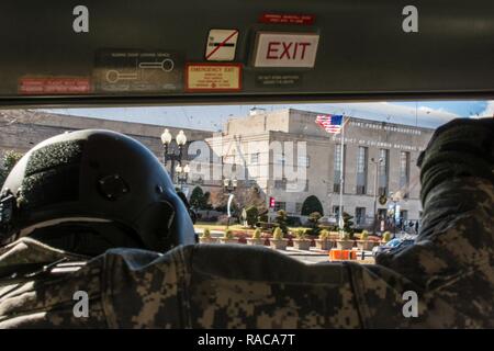 U.S. Army Sgt. Andrew Ricken, a UH-72A Lakota crew chief with Detachment 1, Alpha Company, 1-244, Aviation Security and Support Battalion, D.C. National Guard, checks for clearance as the aircraft lands at the D.C Armory, Washington D.C., January 18, 2017. The crew of the UH-72A performed equipment checks prior to the 58th Presidential Inauguration where Donald J. Trump will be sworn-in as the 45th President of the United States. Military personnel assigned to Joint Task Force D.C. will provide military ceremonial support and defense support of civil authorities during the inaugural period. Stock Photo