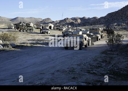 U.S. Soldiers assigned to 1st Battalion, 24th Infantry Regiment, 1st Brigade Combat Team, 25th Infantry Division, prepare to move a Tactical Operations Center during Decisive Action Rotation 17-03 at the National Training Center in Fort Irwin, Calif., Jan. 18, 2017. Decisive Action Rotations at the National Training Center ensure units remain versatile, responsive, and consistently available for current and future contingencies. Stock Photo