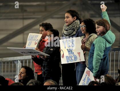 Children hold signs in support of former President Barack Obama during his farewell speech at Joint Base Andrews, Md. Jan. 20, 2017. After his speech Obama and his wife Michelle took time to shake hands and exchange hugs with members of the crowd before boarding a plane to depart. Stock Photo