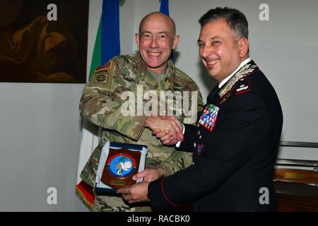 Brig. Gen. Giovanni Pietro Barbano (right), Center of Excellence for Stability Police Units (CoESPU) director, presents  Carabinieri CoESPU crest at Lt. Gen. Charles D. Luckey (left), Commanding General U.S. Army Reserve Command, during visit at Center of Excellence for Stability Police Units (CoESPU) Vicenza, Italy, January 20, 2017.