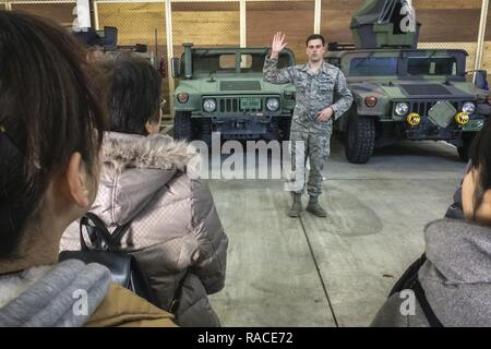 U.S. Air Force Staff Sgt. Justin Beasley, an explosive ordnance disposal technician with the 35th Civil Engineer Squadron, explains how EOD makes use of the M1167 Humvee at home and downrange during a community engagement tour at Misawa Air Base, Japan, Jan. 20, 2017. The M1167 comes equipped with a 6.5-liter turbocharged diesel V-8 engine that nets 190 horsepower and 380 foot-pounds of torque and are protected by armor on all sides of the vehicle. The trucks include special night vision head lights only visible when used with night vision goggles worn on the operator’s helmet. Stock Photo