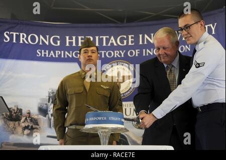 Ret. Gen Hal Hornburg, 27th Commander of Air Education and Training Command, cuts a cake with Airman 1st Class Matthew Turner, AETC commander support staff, at the AETC 75th Extravaganza at Joint Base San Antonio-Randolph, Texas Jan. 23, 2017. The cake-cutting ceremony officially ended the festivities. The event was held to mark the command's 75-year history of training Airmen to fly, fight and win our nation's wars. Stock Photo