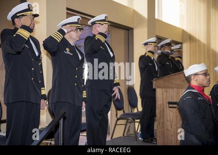 NORFOLK, Va. (Jan. 13, 2017) Distinguished Guests stand and salute the colors during the USS Gonzalez (DDG 66) change of command ceremony. USS Gonzalez is currently undergoing a mid-life upgrade at General Dynamics National Steel and Shipbuilding Company (NASSCO). Stock Photo