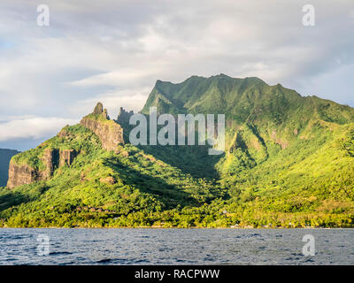 Sunrise approach to Cook Bay with the jagged outline of Mount Rotui, Moorea, Society Islands, French Polynesia, South Pacific, Pacific Stock Photo