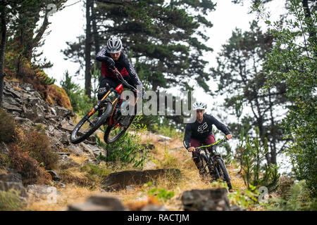 Two mountain bikers ride a rocky a trail at Glyncorrwg in the Afan Valley in South Wales. Stock Photo