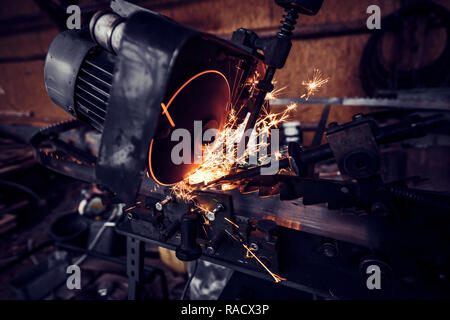 Circular metal sawing, Sparks while grinding iron, close up Stock Photo