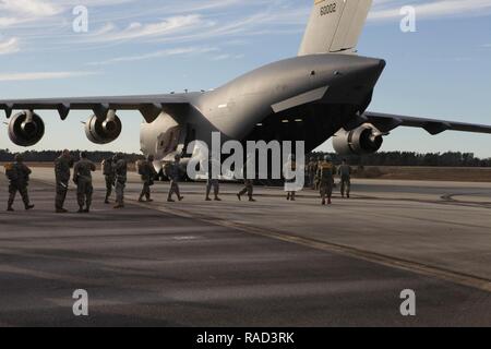 U.S. Army paratroopers assigned to the 360th Civil Affairs Brigade and other supporting units board a U.S. Air Force C-17 Globemaster for a mass tactical Airborne jump for Operation Anvil in North Air Force Auxiliary Base, North, South Carolina, Jan. 26, 2017. The 360th Civil Affairs Brigade hosts Operation Anvil so jumpmasters can perform duties and jumpers can maintain currency for jump status. Stock Photo