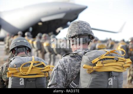 United States Army paratroopers assigned to the 360th Civil Affairs Brigade, 412th Civil Affairs Battalion, 450th Civil Affairs Battalion, begin to board a Boeing C-17 Globemaster, North Air Force Auxiliary Base, S.C., Jan. 26, 2016. The 360th Civil Affairs Brigade host Operation Anvil so jumpmasters and jumpers can maintain currency and jump status. Stock Photo